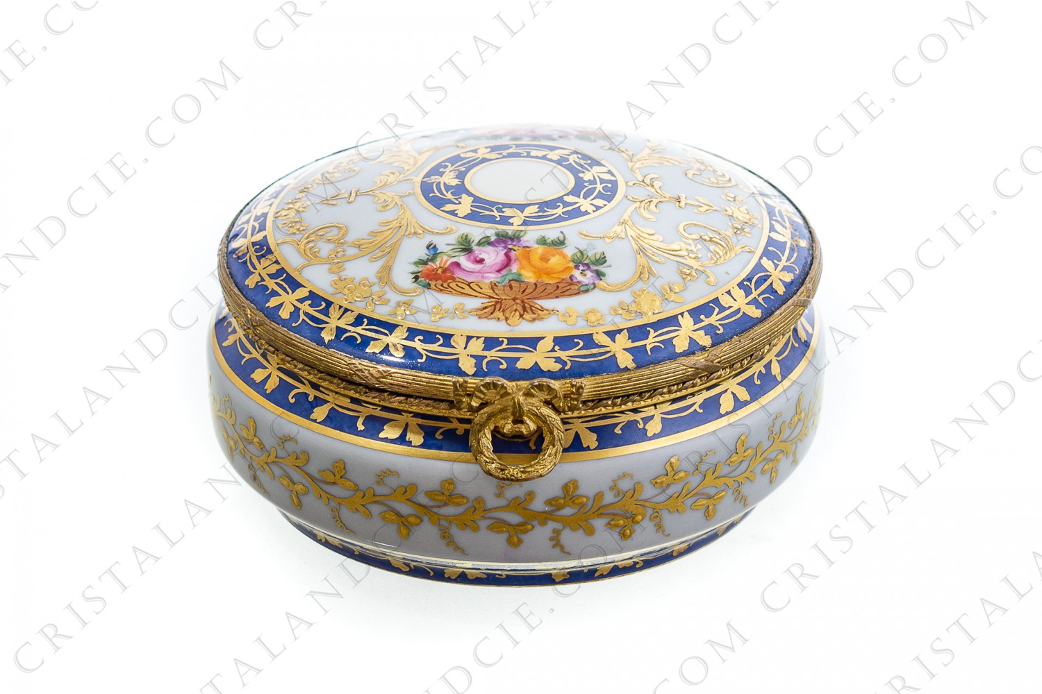 Round box in china hand decorated by the workshops Le Tallec at Paris, decorated with polychromes bouquets of flowers, gold enameled arabesques and gold friezes of leaves on a blue background photo-1