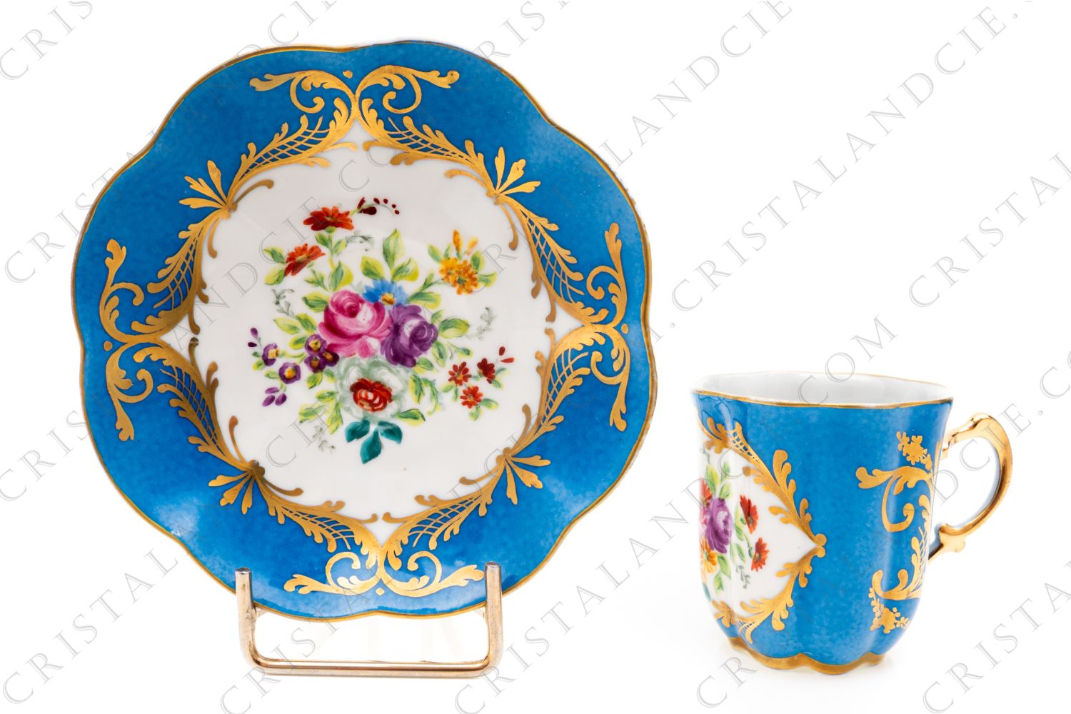 Coffee cup in china hand decorated by the workshops Le Tallec, decorated with hand painted polychrome flowers on a blue background and gold arabesque photo-1