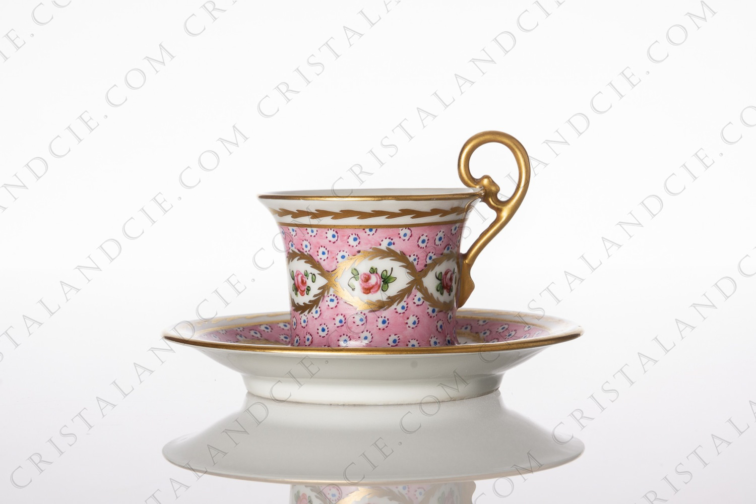 Coffee cup in Sevres china with a hand painted pattern of roses on a pink background gold enhanced photo-1