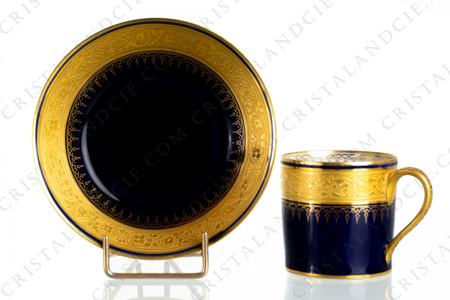 Litron cup in china decorated with foliage in gold inlays on a cobalt blue backgroung, the handle is decorated with a hand painted frieze on a mat gold background photo-1