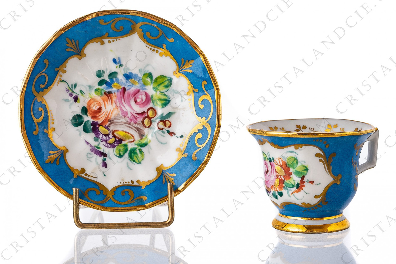Moka cup in china hand painted by the workshop Le Tallec decorated with polychromes bouquets of flowers on a blue background and with gold borders and arabesques photo-1