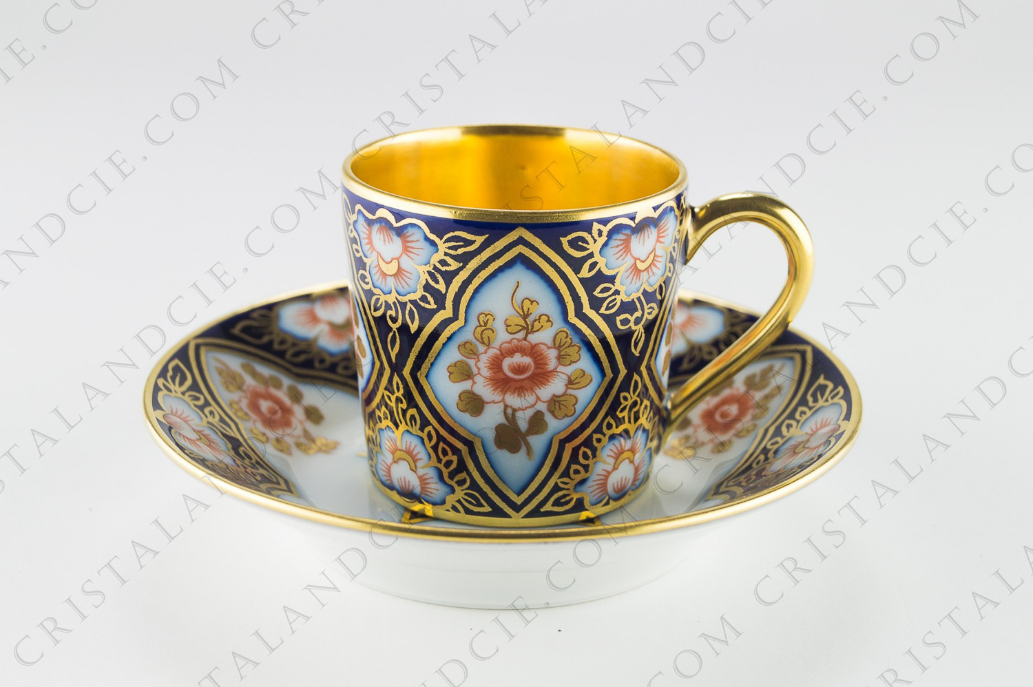 Moka cup in Limoges china by Bernardaud, decorated with flowers and gold friezes on a cobalt blue background photo-1